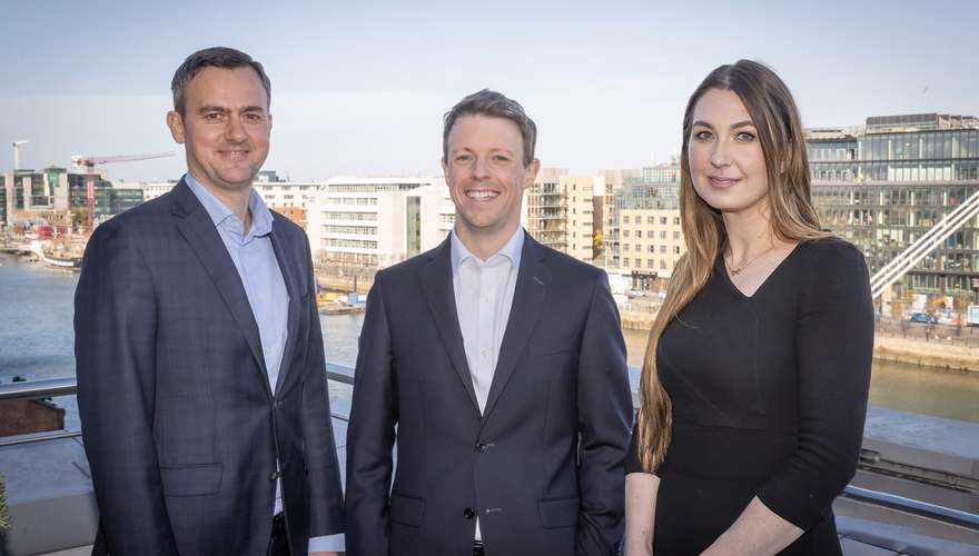 Three people pictured on a balcony overlooking Dublin